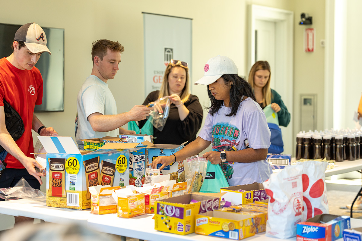 Students pack backpacks for donation