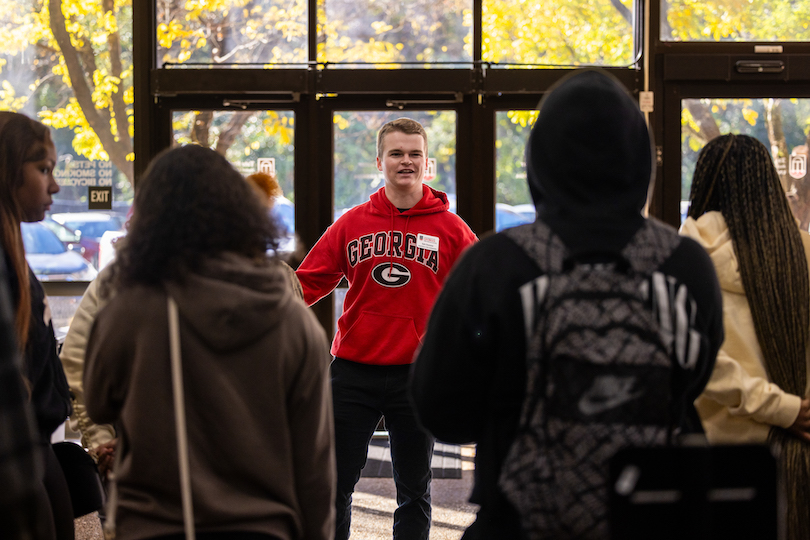 Kyle Huemme talks to a group of high school students on a campus tour. 