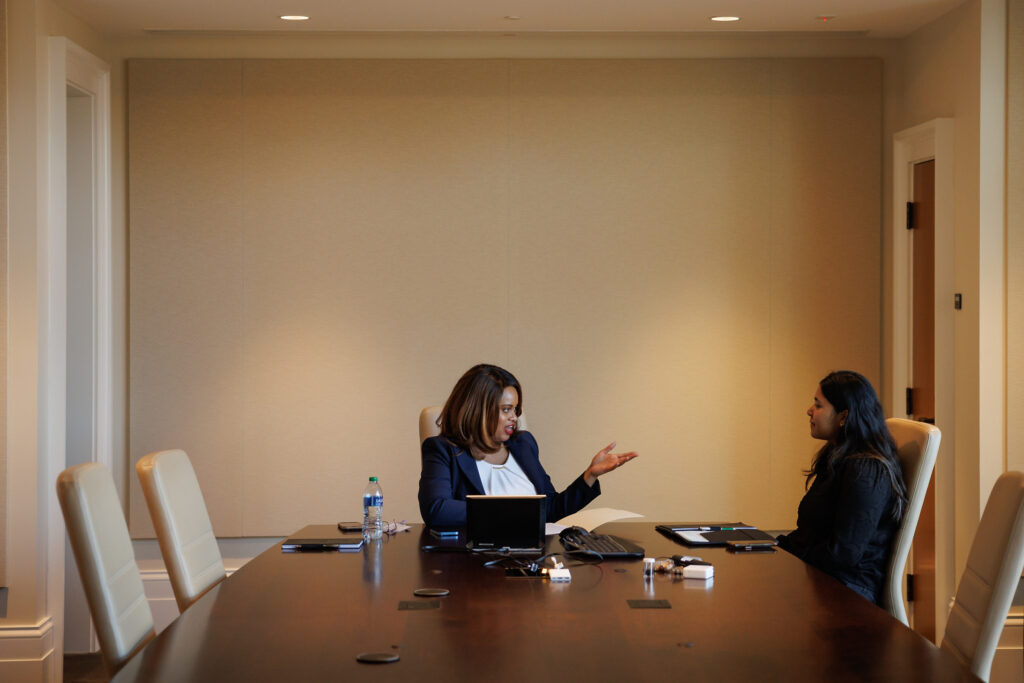 Two women talking with each other in a conference room