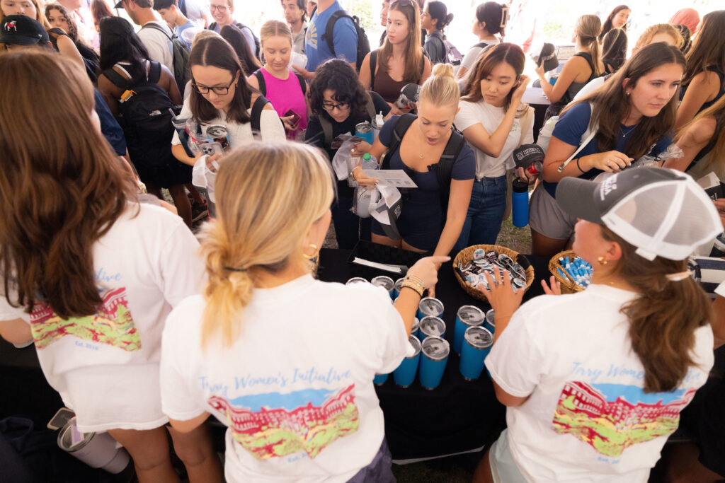 Students gather Terry swag items  leader at the Terry College Back to Business resource fair. 