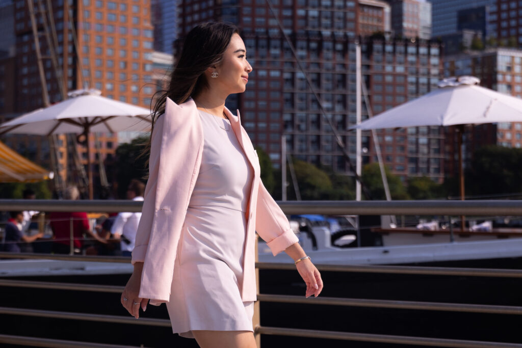 Jasmine Chen walking in a pink suit.