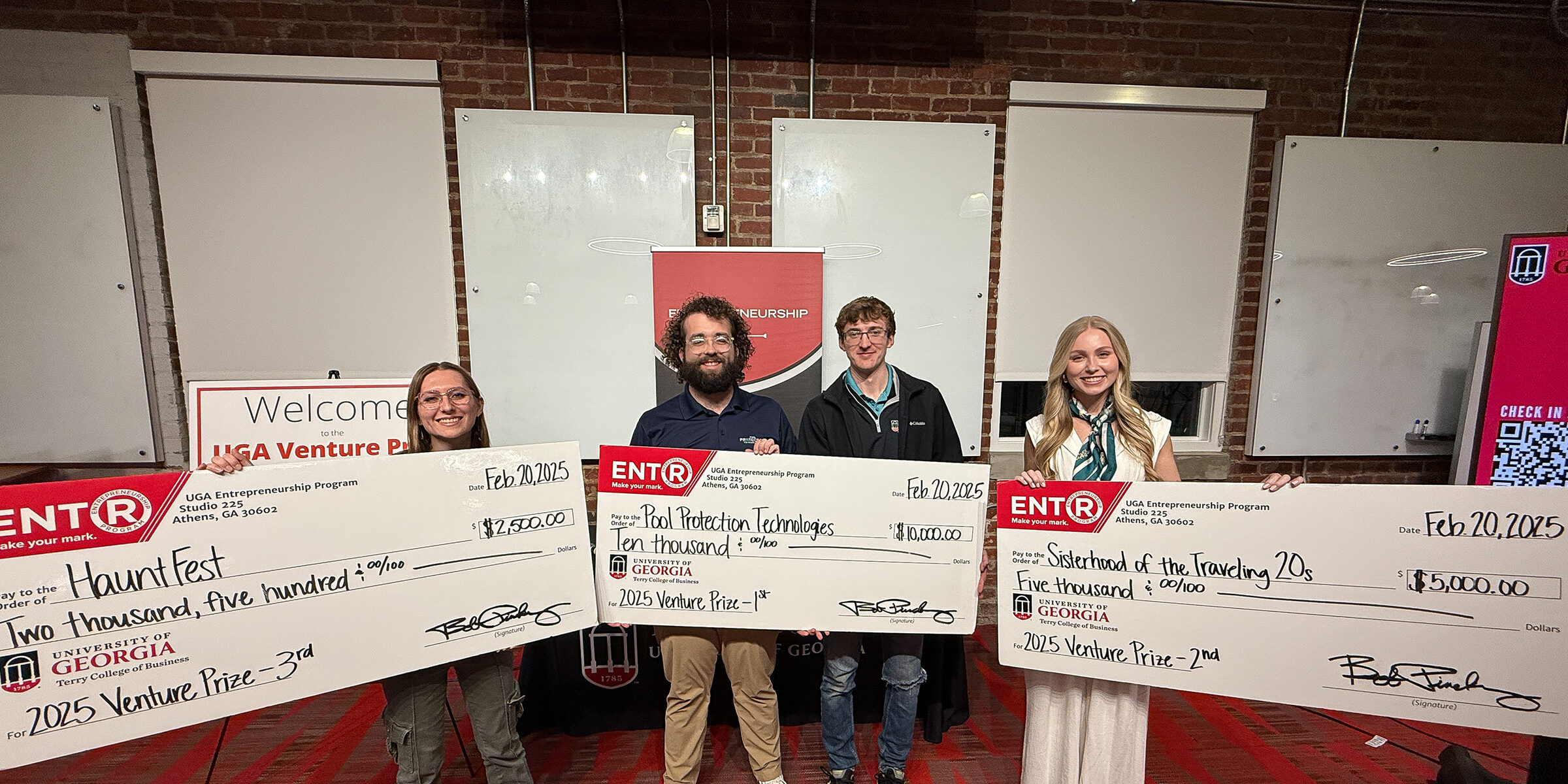 Winners of the 2025 UGA Venture Prize stand with their prize checks at the Truist Pitch Deck at Studio 225.
