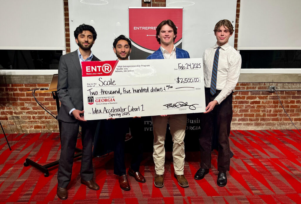 Winners of the Spring UGA Idea Accelerator Pitch Contest stand with a giant prize check.