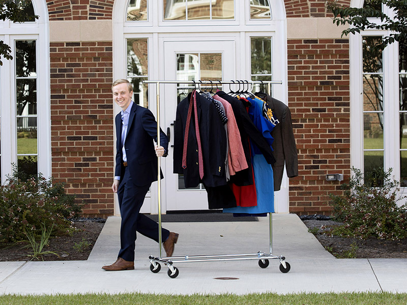 Matthew McDaniel transports outfits destined for UGA’s Professional Clothing Closet.