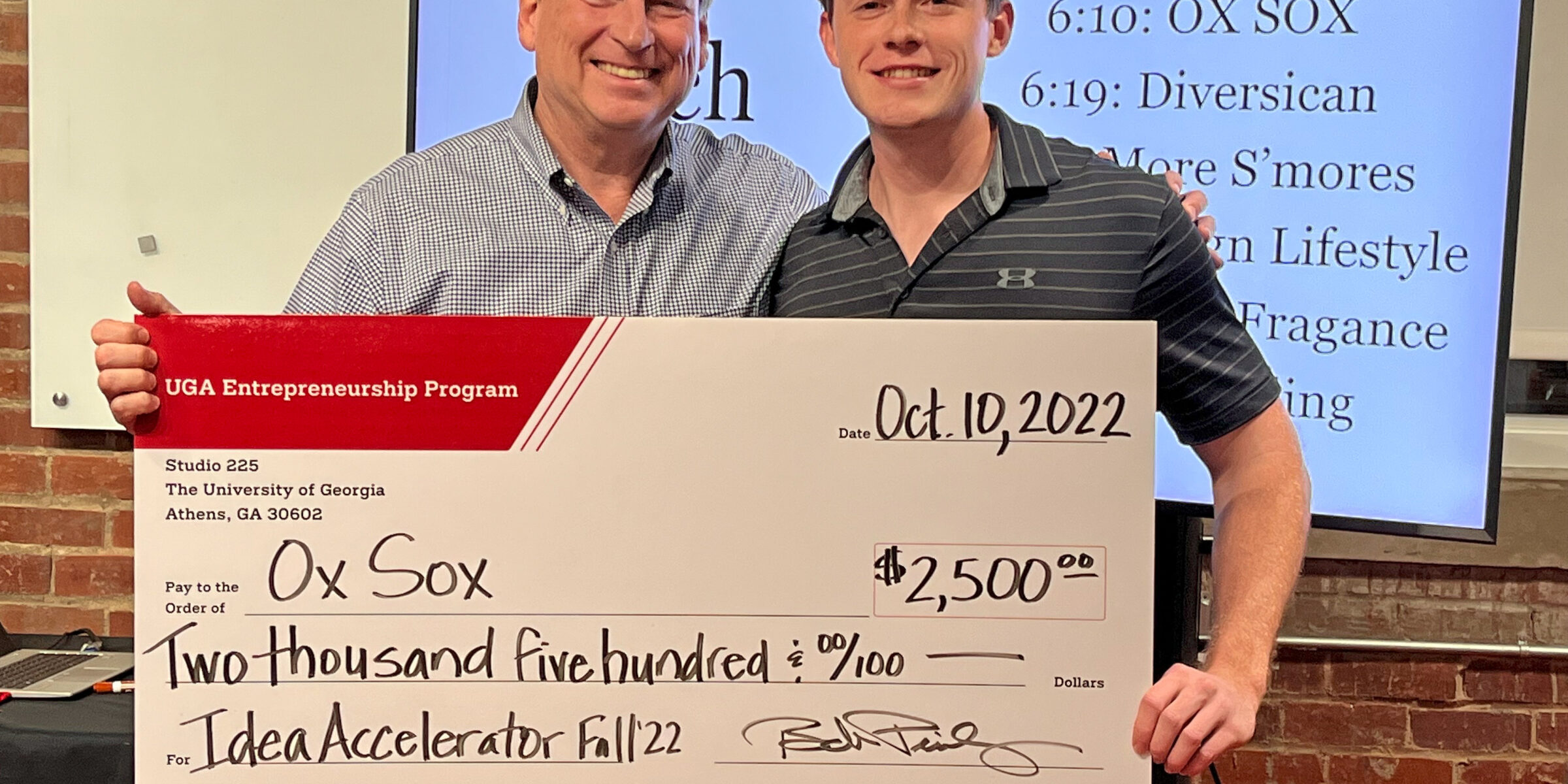 Bob Pinckney and Matt Tesvich holding a novelty prize check
