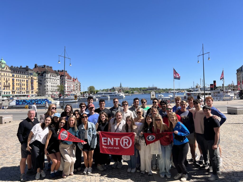 Students stand in front of historic port in Finland