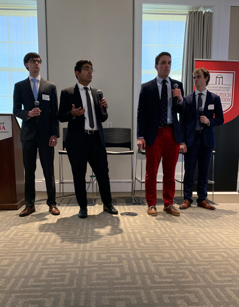 Four students pitching to an audience