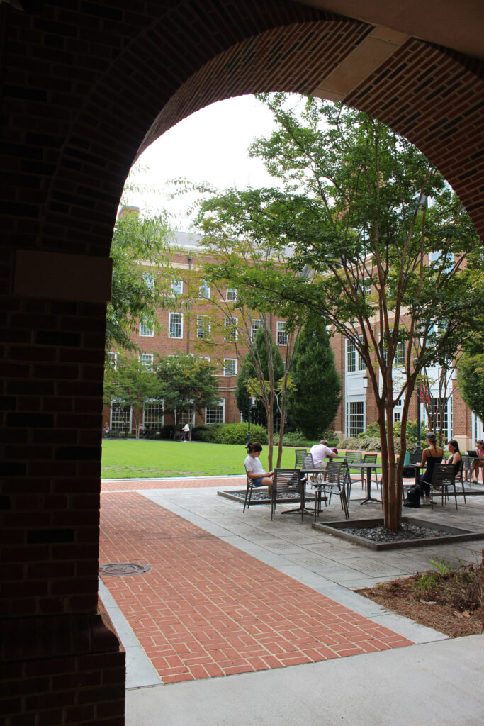 brick pathway viewed through arched entrance