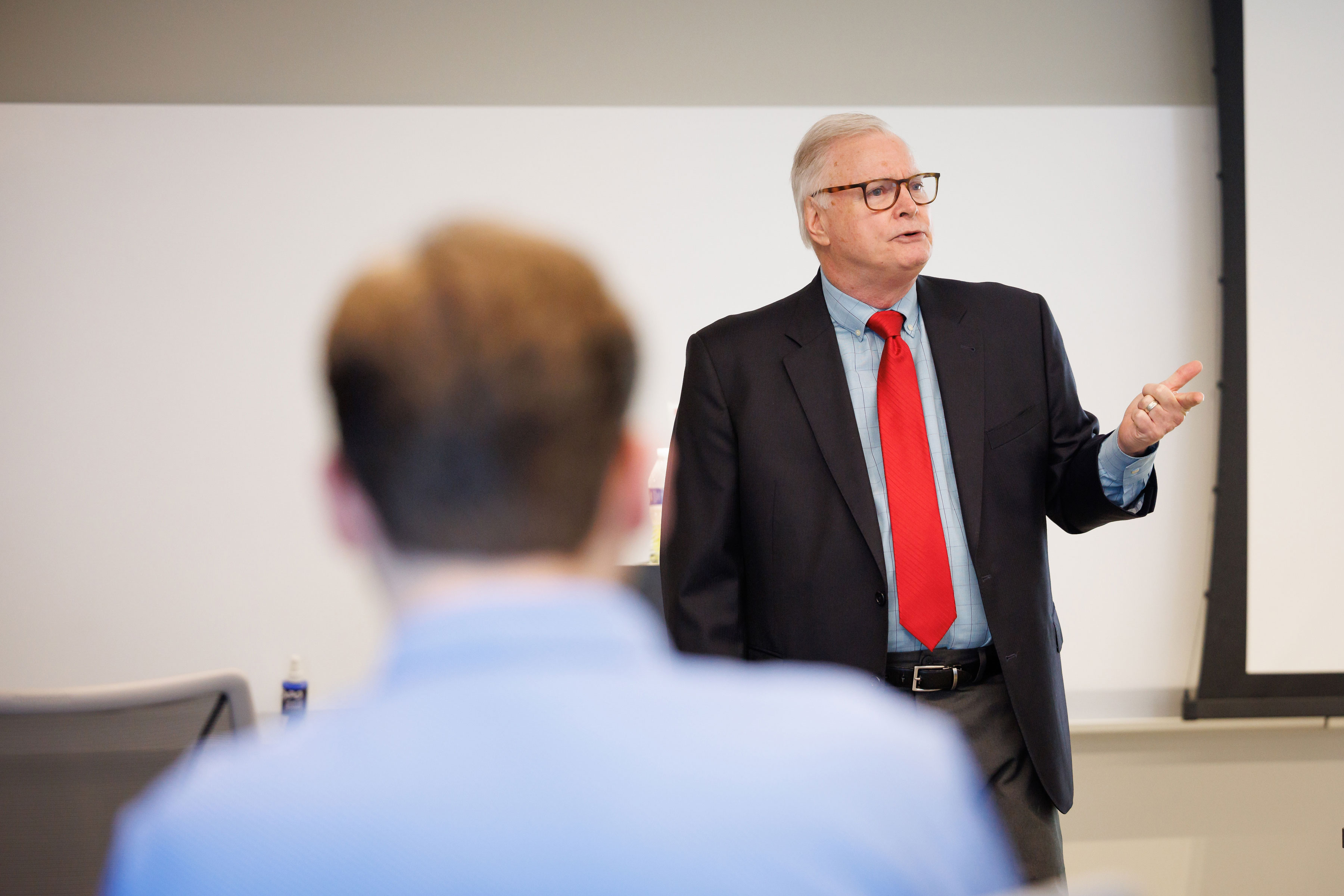A man standing at the front of the room giving a lecture